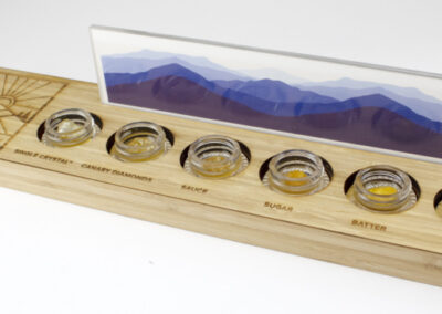 Custom wood display, laser cut and engraved with plexiglass display window and fake display hash: fake single crystal, fake canary diamonds, fake sauce, fake sugar, fake batter, fake budder.